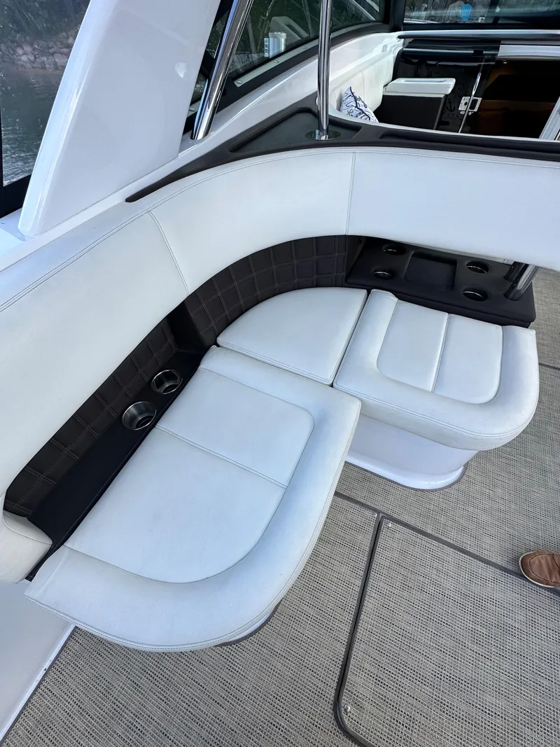 Slide: The Image of 2015 Cobalt A40 boat with white leather seating and cup holders. - 27