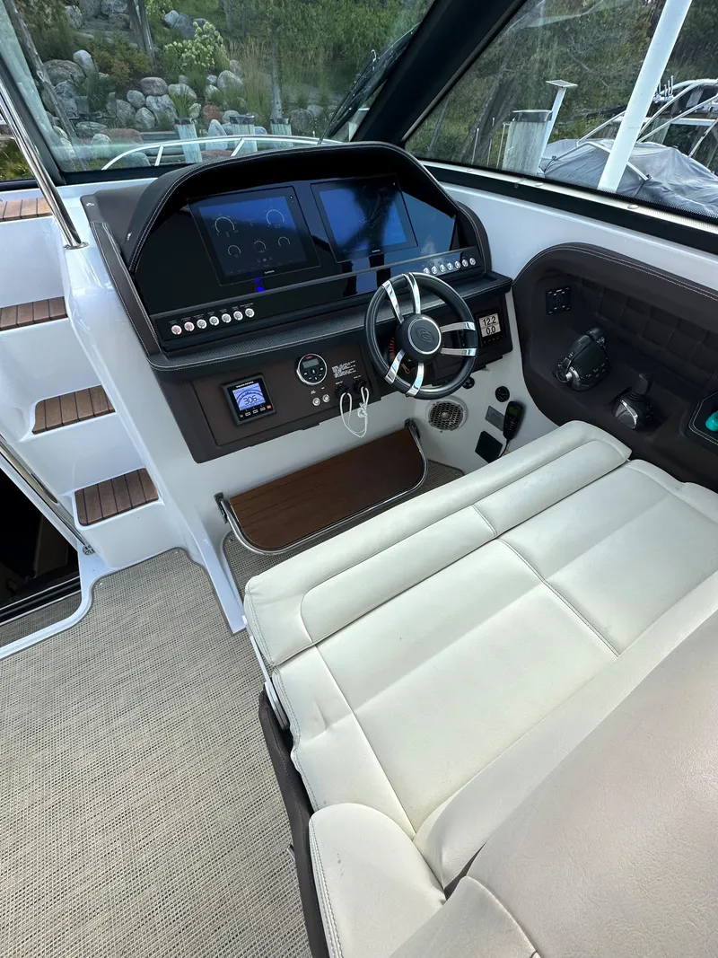 Slide: The Image of 2015 Cobalt A40 boat cockpit with modern controls and leather seating. - 28