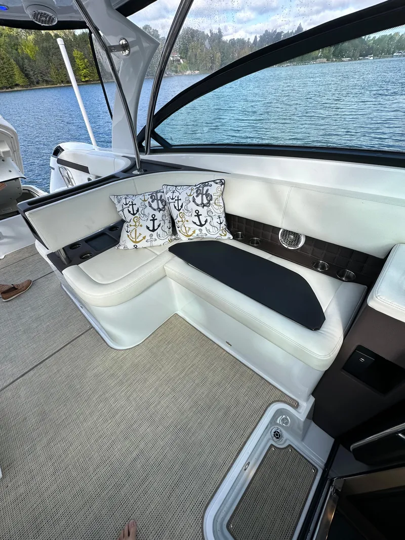 Slide: The Image of Interior seating area of a 2015 Cobalt A40 boat with anchor-themed pillows. - 29
