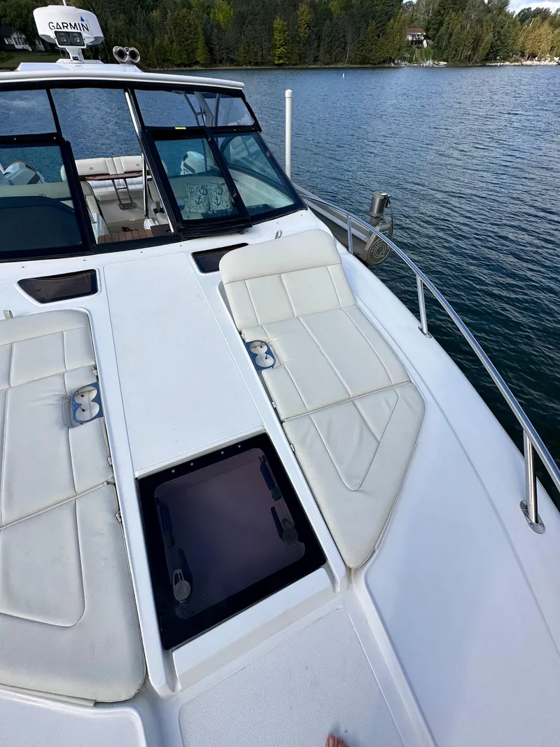 Slide: The Image of 2015 Cobalt A40 boat with sun loungers on a serene lake. - 34