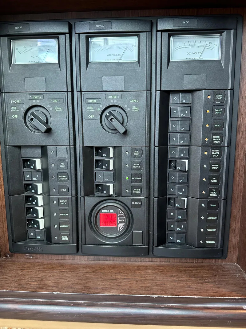 Slide: The Image of Control panel of a 2015 Cobalt A40 boat with various switches and gauges. - 38