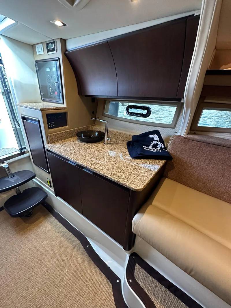 Slide: The Image of 2015 Cobalt A40 boat interior with kitchenette and seating area. - 39