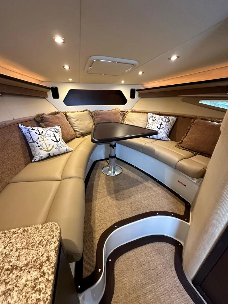 Slide: The Image of Luxurious interior of a 2015 Cobalt A40 yacht with plush seating and anchor-themed pillows. - 41