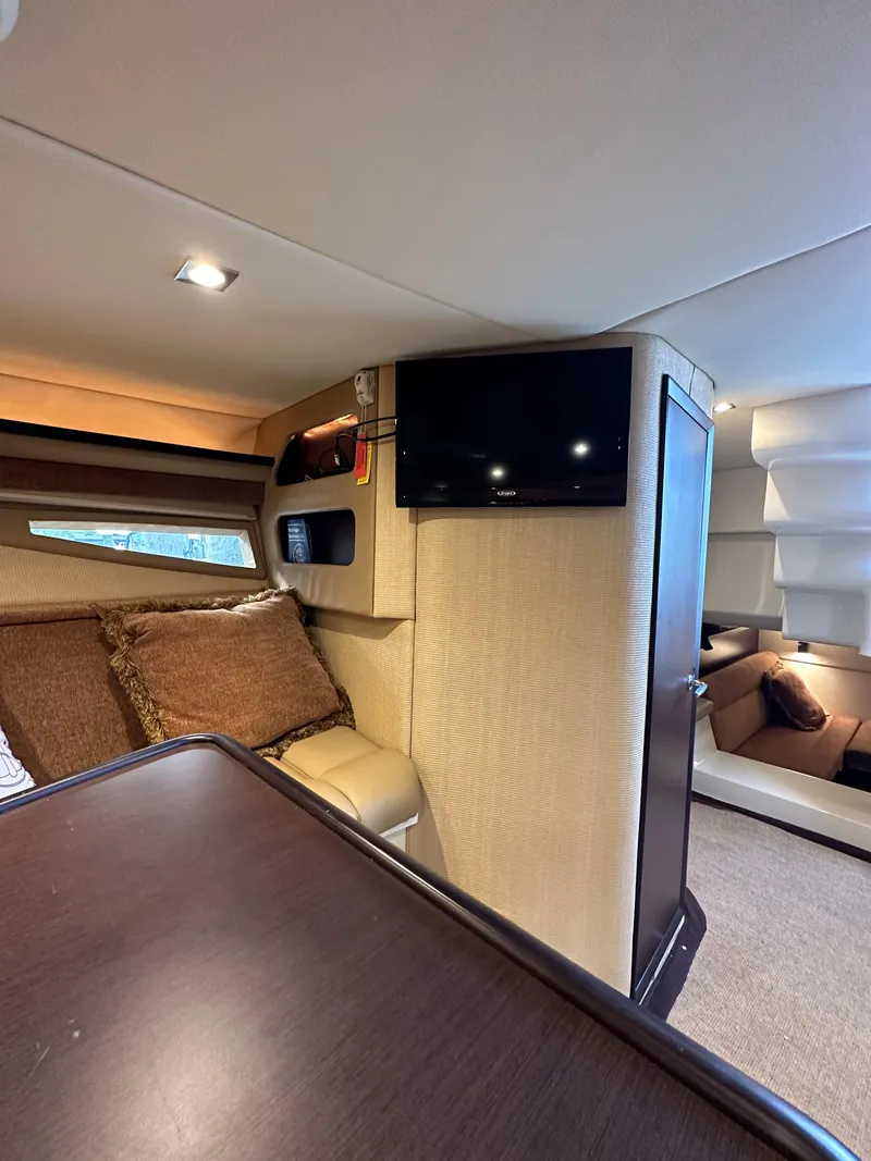 Slide: The Image of Interior of 2015 Cobalt A40 boat with TV, seating, and cushions. - 42