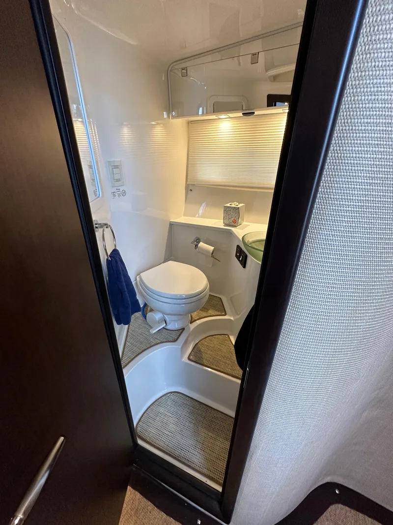 Slide: The Image of Compact bathroom in a 2015 Cobalt A40 boat with modern fixtures. - 44
