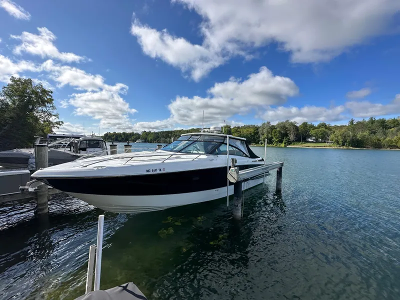 Slide: The Image of 2015 Cobalt A40 boat docked on a sunny day with blue skies and calm water. - 47