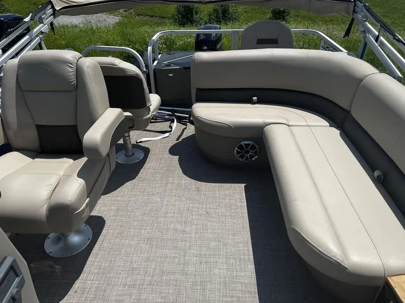 Slide: The Image of 2024 Sun Tracker Bass Buggy 18 DLX pontoon boat interior with beige seating. - 4