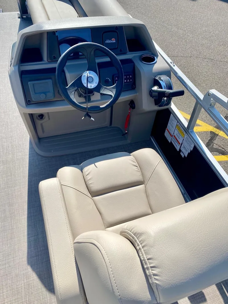 Slide: The Image of 2024 Sun Tracker Party Barge 18 DLX helm with steering wheel and captain's chair. - 4