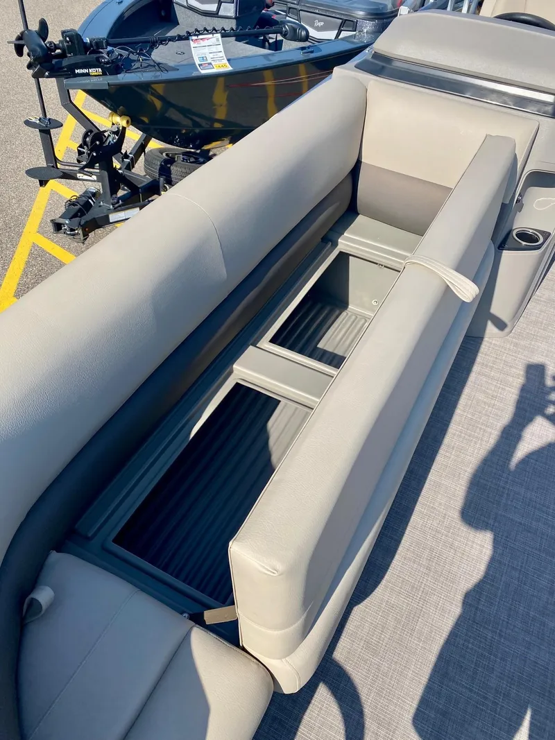 Slide: The Image of 2024 Sun Tracker Party Barge 18 DLX interior seating and storage compartment. - 5