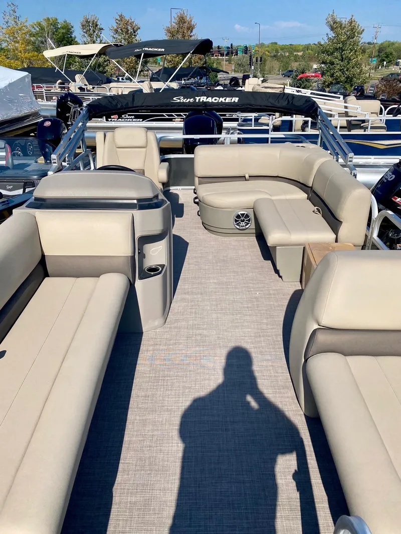 Slide: The Image of 2024 Sun Tracker Party Barge 18 DLX pontoon boat with beige seating and spacious deck. - 6
