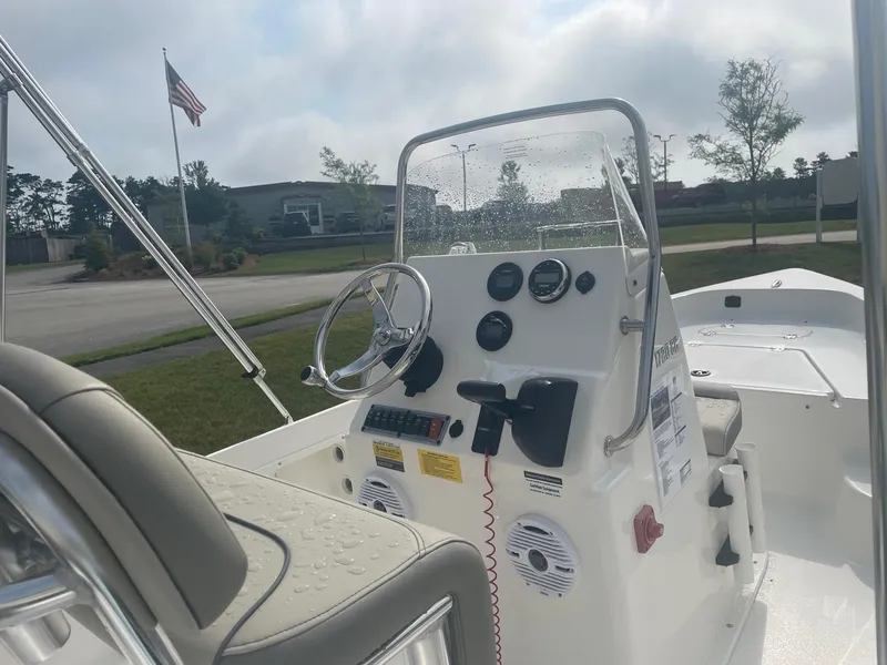 Slide: The Image of 2024 Key West 1720 Center Console boat interior with steering wheel and controls. - 2