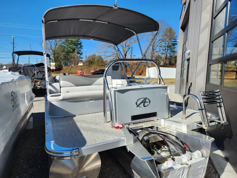 Slide: The Image of 2024 Avalon Platinum LSZ 1985 CRB pontoon boat with canopy, docked outdoors. - 2