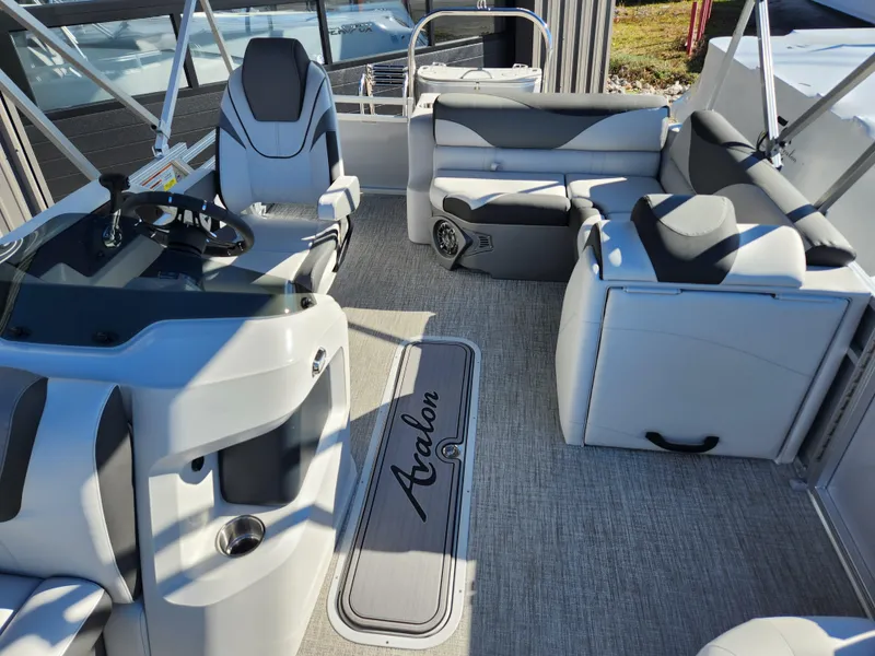 Slide: The Image of Avalon Platinum LSZ 1985 CRB 2024 boat interior with modern seating and steering console. - 4