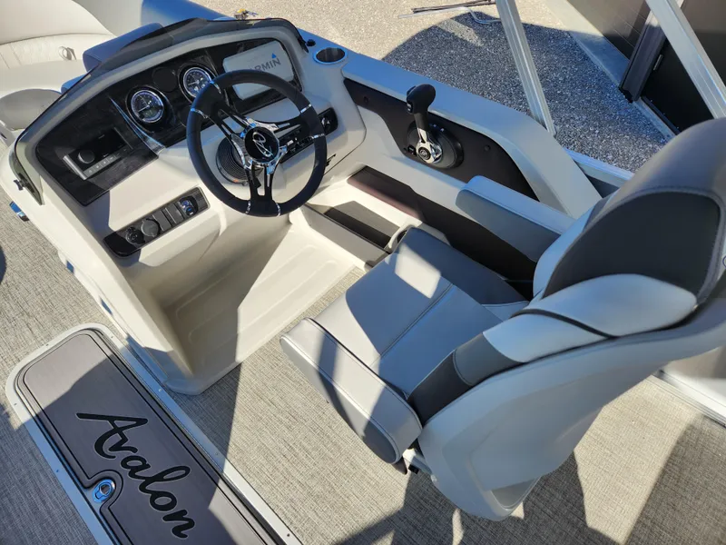 Slide: The Image of 2024 Avalon Platinum LSZ 1985 CRB boat interior with steering wheel and seating. - 5