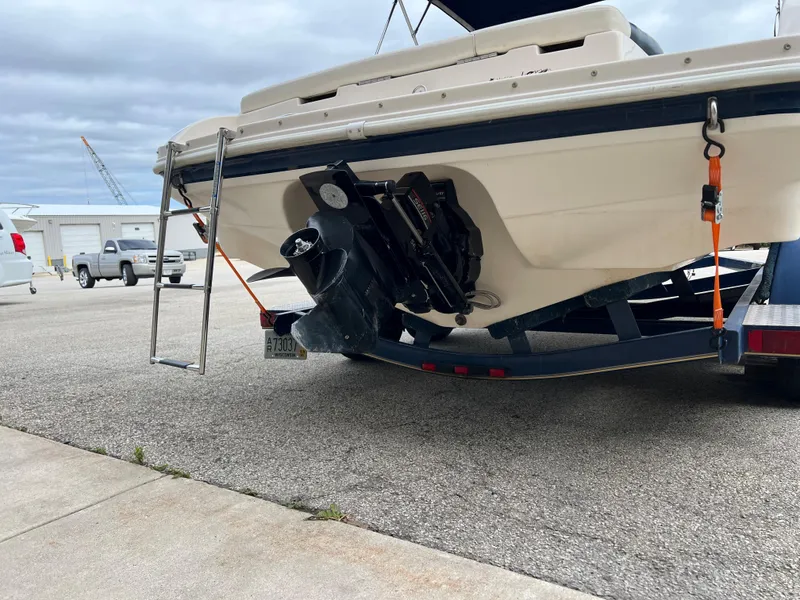 Slide: The Image of 2002 Rinker 212 Captiva Bowrider on trailer, rear view with outboard motor. - 10