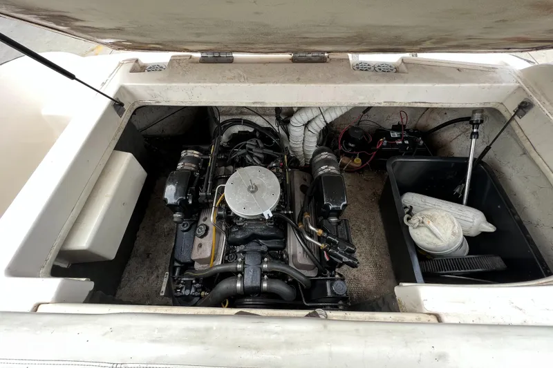 Slide: The Image of 2002 Rinker 212 Captiva Bowrider engine compartment with visible engine and storage area. - 18