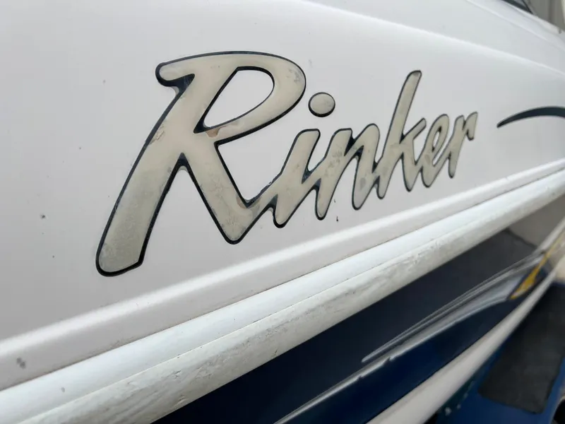 Slide: The Image of Close-up of 2002 Rinker 212 Captiva Bowrider boat logo. - 19