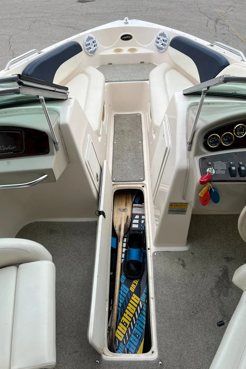 Slide: The Image of 2002 Rinker 212 Captiva Bowrider interior with storage compartment open. - 4
