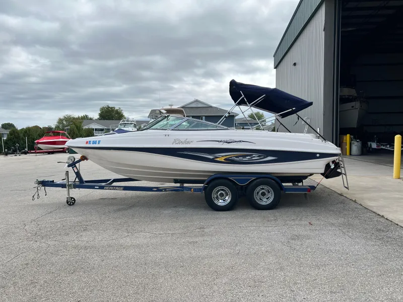 Slide: The Image of 2002 Rinker 212 Captiva Bowrider on trailer near storage facility. - 5