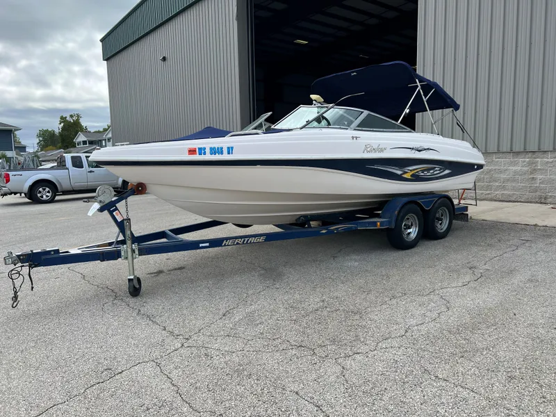 Slide: The Image of 2002 Rinker 212 Captiva Bowrider on a trailer outside a storage facility. - 6
