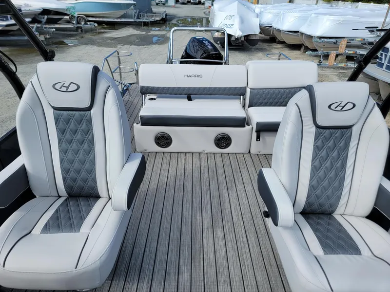Slide: The Image of 2024 Harris Sunliner 230 Sport boat interior with luxury seating and modern design. - 10