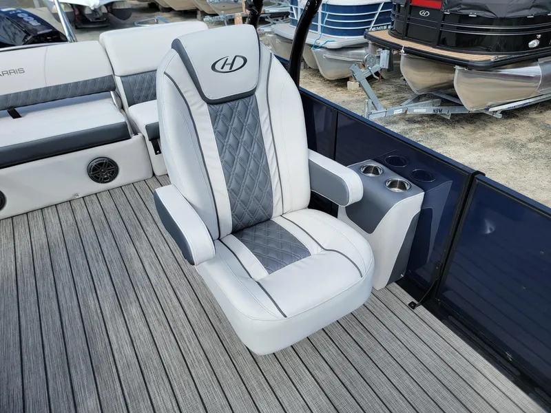 Slide: The Image of Captain's chair on 2024 Harris Sunliner 230 Sport pontoon boat with cup holders. - 11