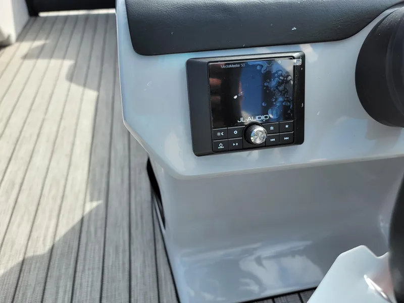 Slide: The Image of 2024 Harris Sunliner 230 Sport boat dashboard with JL Audio system. - 15