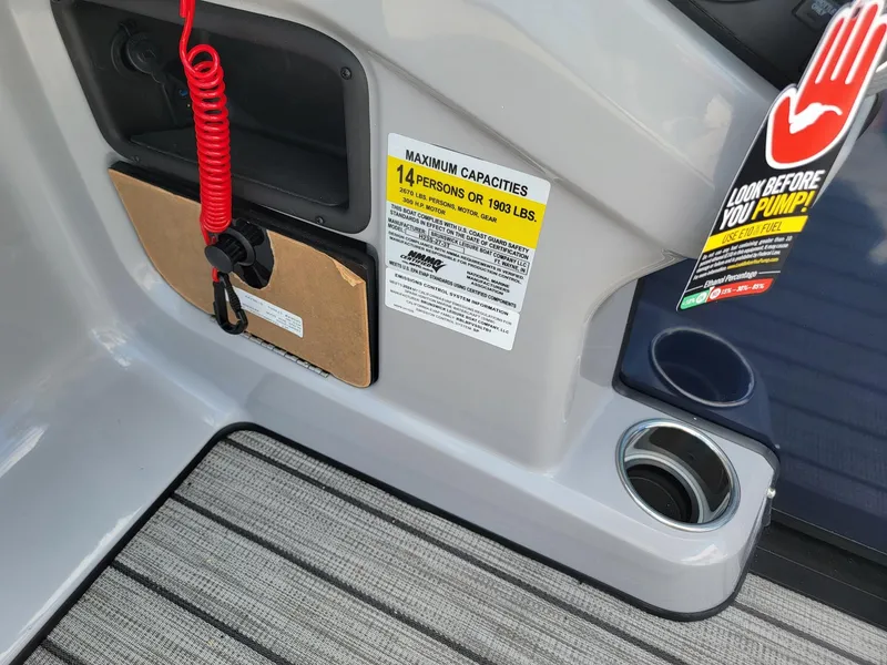 Slide: The Image of 2024 Harris Sunliner 230 Sport boat interior with capacity label and safety instructions. - 17