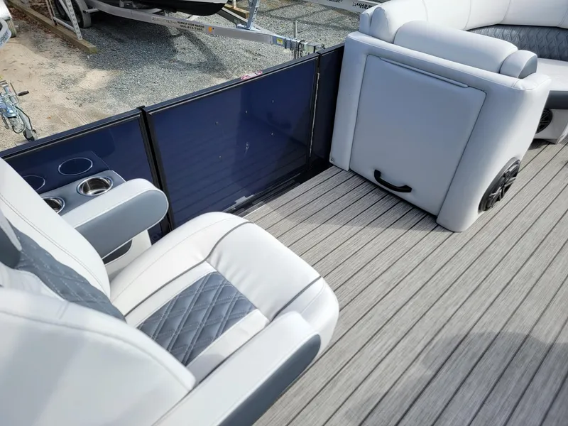 Slide: The Image of 2024 Harris Sunliner 230 Sport boat interior with luxurious seating and cup holders. - 26