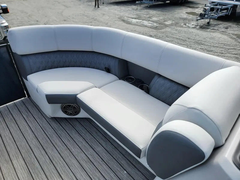 Slide: The Image of 2024 Harris Sunliner 230 Sport boat interior with plush seating and cup holders. - 29