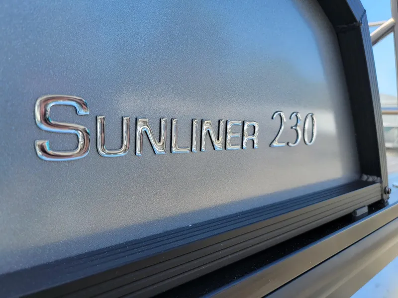 Slide: The Image of Close-up of 2024 Harris Sunliner 230 Sport boat model name. - 33