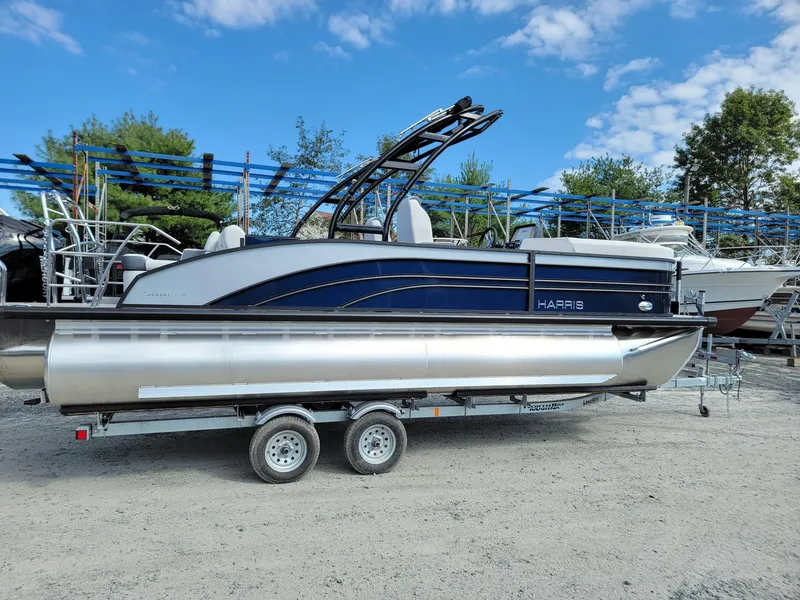 Slide: The Image of 2024 Harris Sunliner 230 Sport pontoon boat on a trailer. - 6