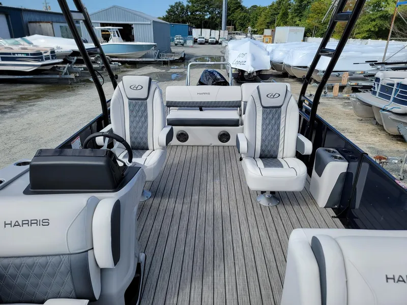 Slide: The Image of 2024 Harris Sunliner 230 Sport pontoon boat interior with luxury seating and modern design. - 7