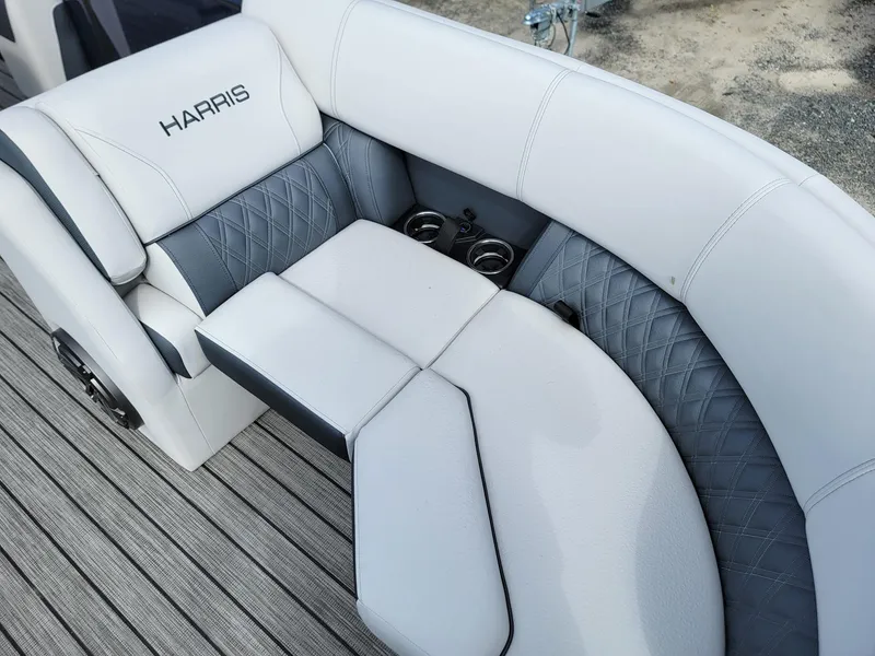 Slide: The Image of 2024 Harris Sunliner 230 Sport boat interior with white and gray seating. - 9