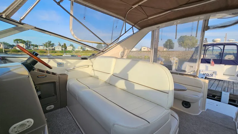 Slide: The Image of Interior seating area of a 1999 Maxum 3000 SCR boat with beige upholstery. - 10