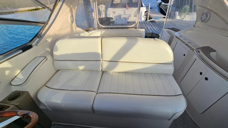 Slide: The Image of Interior seating of a 1999 Maxum 3000 SCR boat with white upholstery. - 11