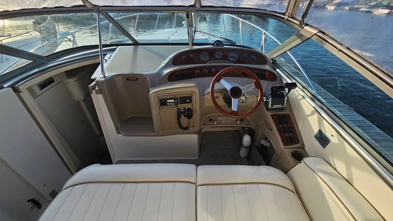 Slide: The Image of 1999 Maxum 3000 SCR boat cockpit with steering wheel and control panel. - 13