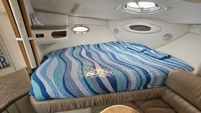 Slide: The Image of Interior cabin of 1999 Maxum 3000 SCR with a cozy bed and porthole windows. - 18