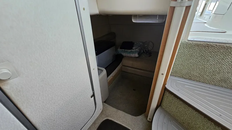 Slide: The Image of 1999 Maxum 3000 SCR cabin interior with seating and storage. - 22