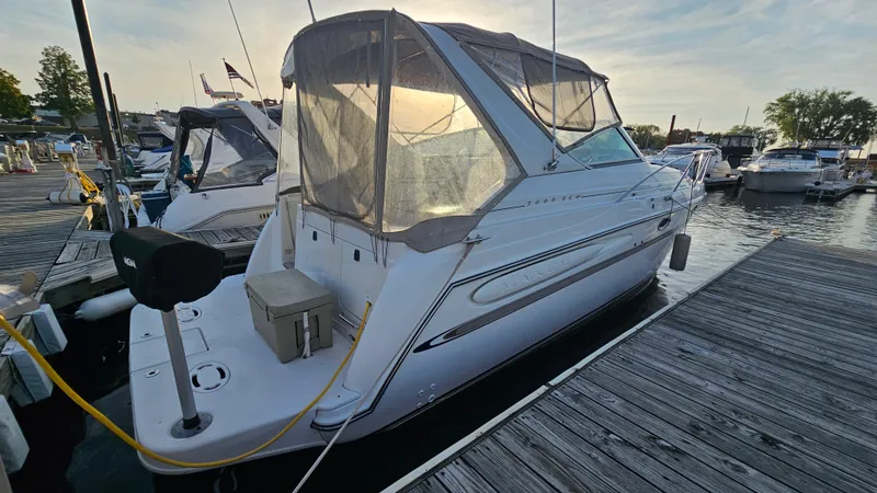 Slide: The Image of 1999 Maxum 3000 SCR boat docked at a marina. - 3