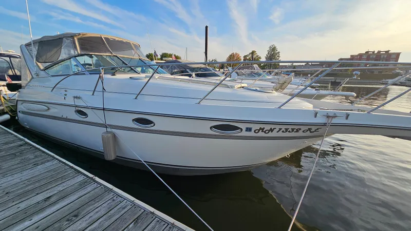 Slide: The Image of 1999 Maxum 3000 SCR boat docked at a marina. - 4