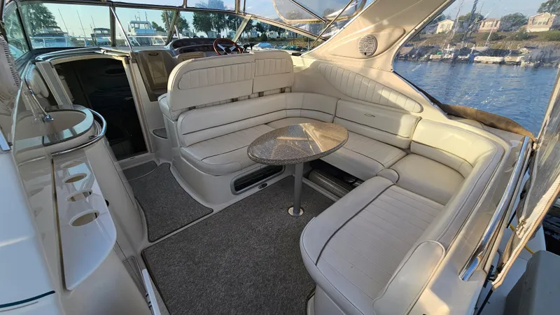 Slide: The Image of 1999 Maxum 3000 SCR boat interior with spacious seating and table. - 7