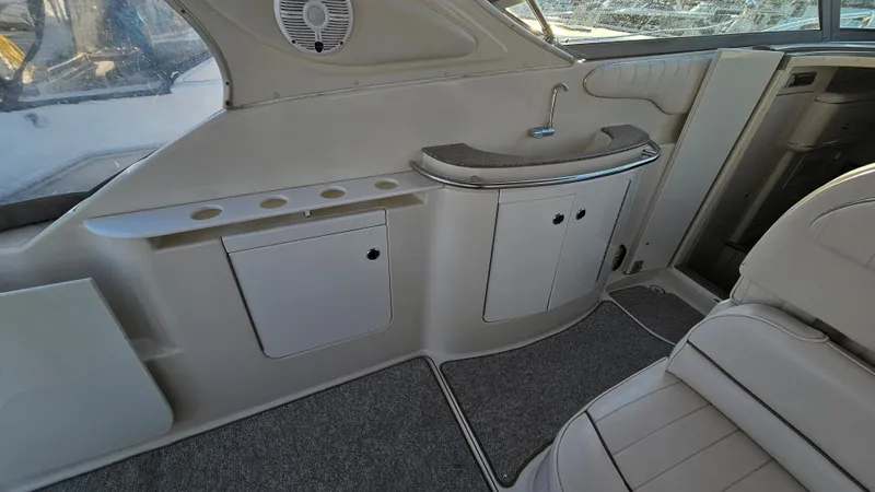 Slide: The Image of Interior of a 1999 Maxum 3000 SCR boat with storage cabinets and cup holders. - 9