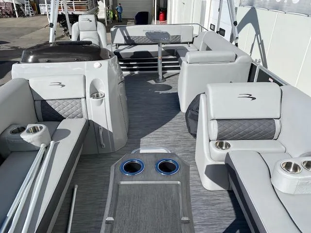 Slide: The Image of 2023 Bennington 25LSB pontoon boat interior with gray seating and cup holders. - 10