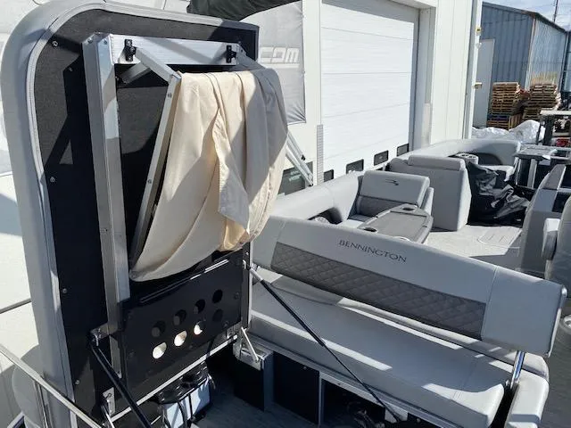 Slide: The Image of 2023 Bennington 25LSB pontoon boat interior with seating and storage. - 6