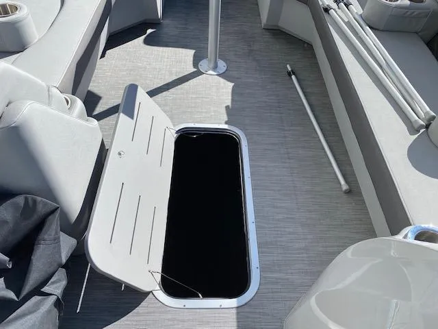 Slide: The Image of 2023 Bennington 25LSB boat interior with open storage compartment. - 9