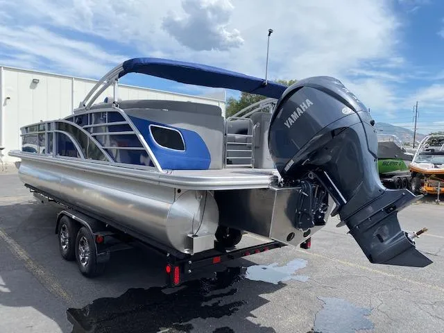 Slide: The Image of 2023 Bennington 25LTFB pontoon boat with Yamaha outboard motor on trailer. - 3