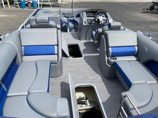 Slide: The Image of 2023 Bennington 25LTFB pontoon boat interior with gray and blue seating. - 7