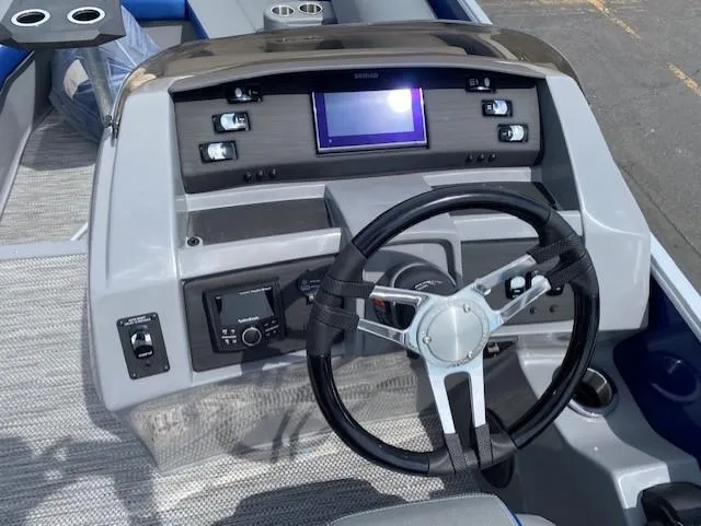 Slide: The Image of 2023 Bennington 25LTFB boat dashboard with steering wheel and control panel. - 8