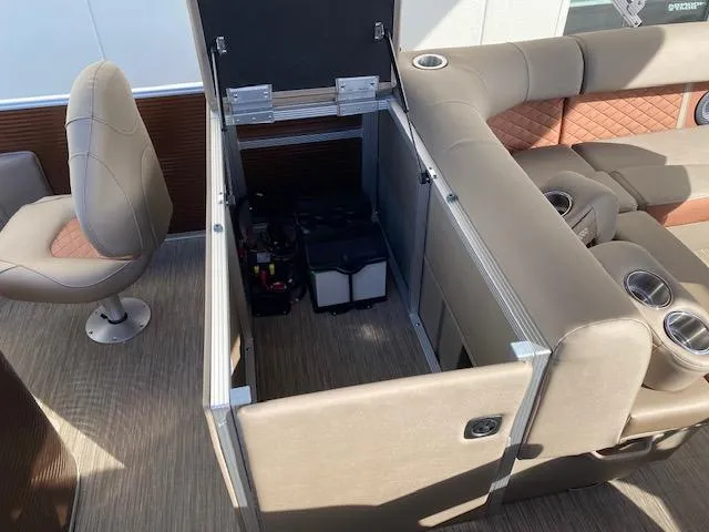 Slide: The Image of 2023 Bennington 22LFAPG pontoon boat with open storage compartment and seating area. - 10